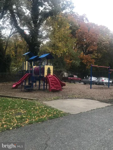 a childrens park with lots of swings and slides