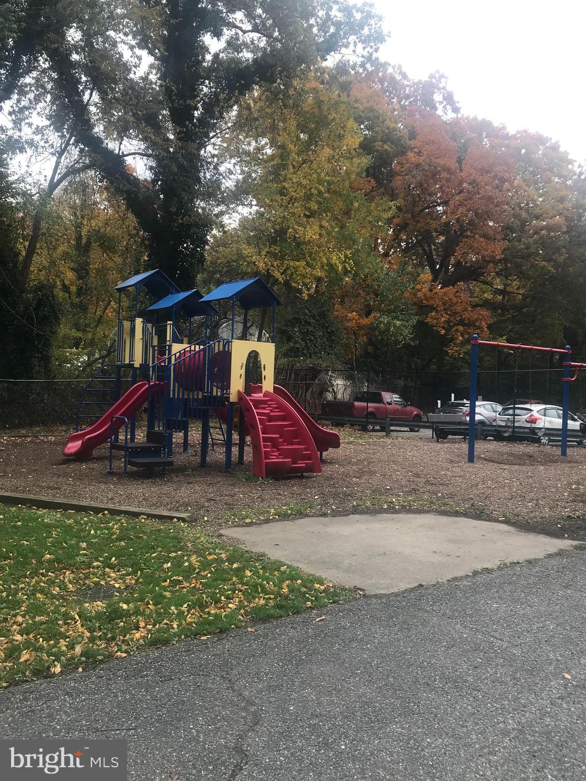 8830 Piney Branch Road, Unit 1004 Silver Spring, MD 20903 - Photo 16 of 16 a childrens park with lots of swings and slides