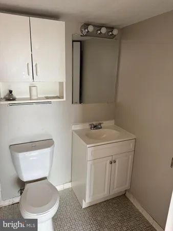 a bathroom with a toilet sink and mirror