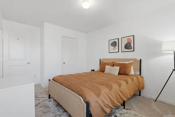 a bedroom with a bed and a wall painting