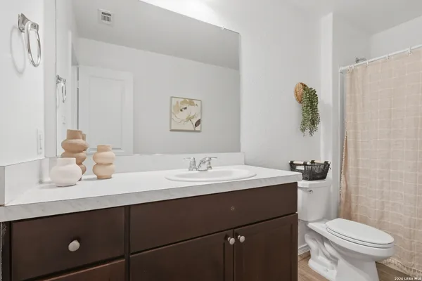 a bathroom with a sink a toilet and a mirror