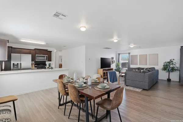 a view of a dining room with furniture and wooden floor
