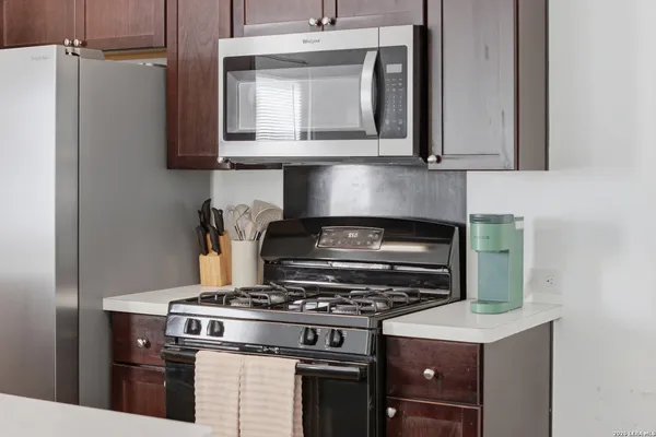 a stove top oven sitting inside of a kitchen