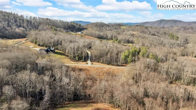 a view of a yard with wooden fence