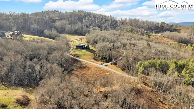 a view of a yard with wooden fence