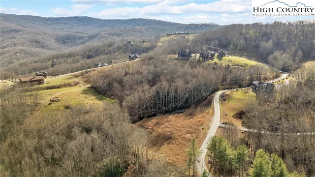 a view of a house with a mountain and a forest