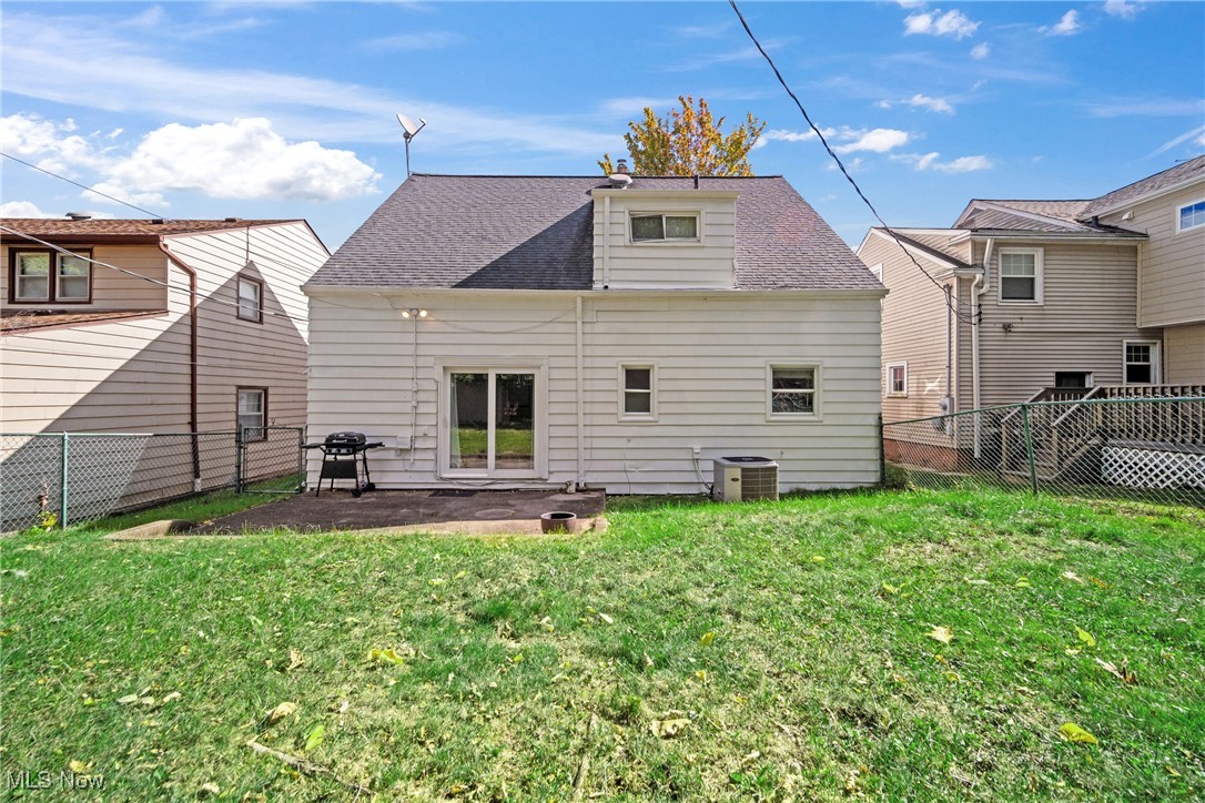 2440 White Road Cleveland, OH 44118 - Photo 6 of 43 Back of property featuring central AC and a lawn
