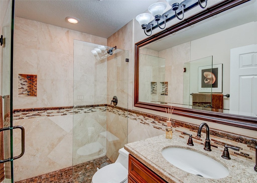 2 High Bluff Laguna Niguel, CA 92677 - Photo 16 of 37 a bathroom with a sink mirror and a bathtub