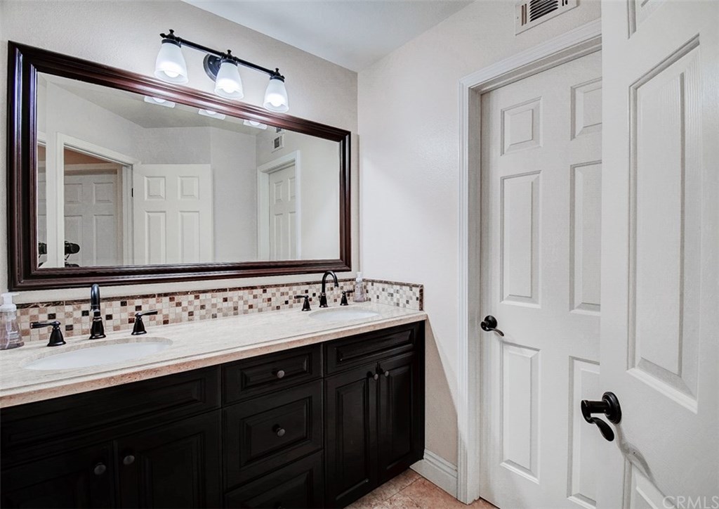 2 High Bluff Laguna Niguel, CA 92677 - Photo 20 of 37 a bathroom with a double vanity sink and a mirror