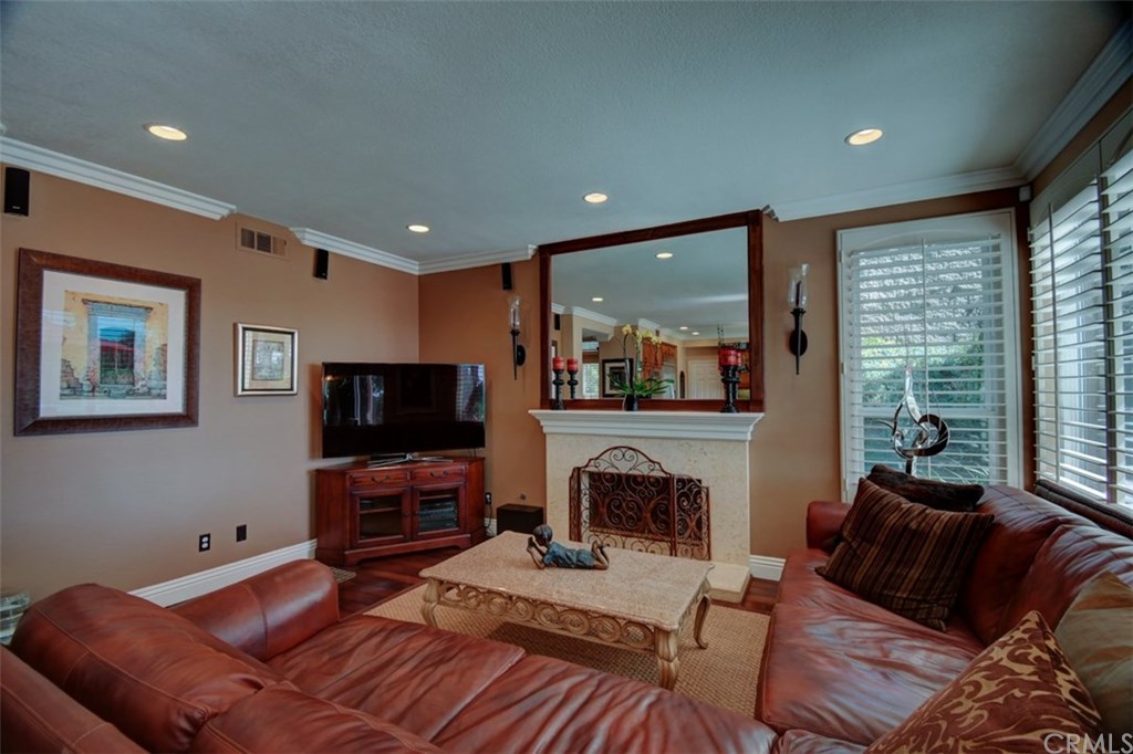 2 High Bluff Laguna Niguel, CA 92677 - Photo 9 of 37 a living room with furniture a flat screen tv and a fireplace