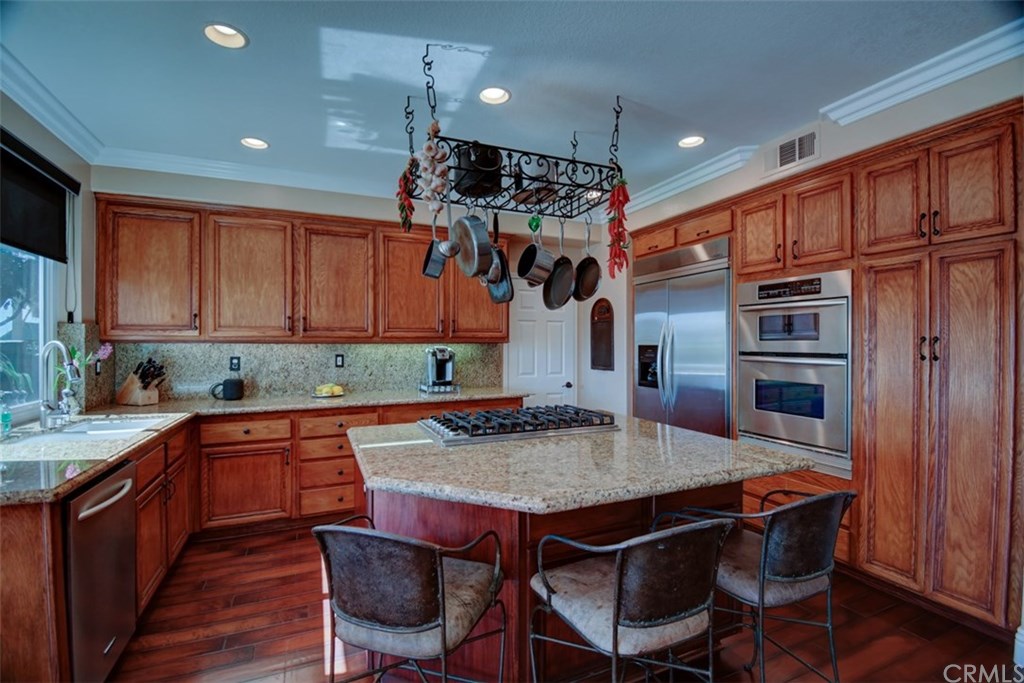 2 High Bluff Laguna Niguel, CA 92677 - Photo 10 of 37 a kitchen with stainless steel appliances granite countertop a table chairs sink refrigerator and cabinets