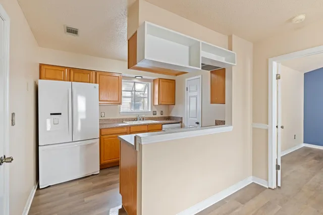 a spacious bathroom with a granite countertop sink and a bathtub
