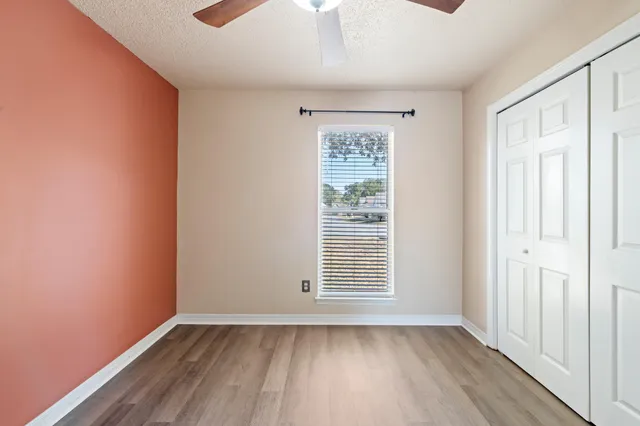 a bathroom with a granite countertop sink mirror vanity and a toilet