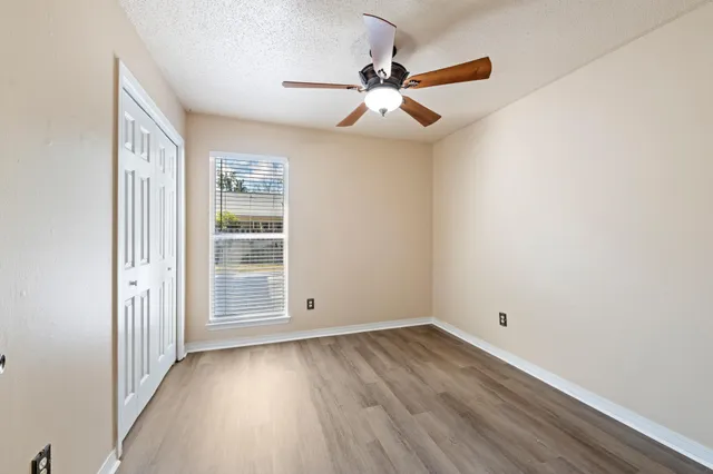 a view of a swimming pool with wooden fence