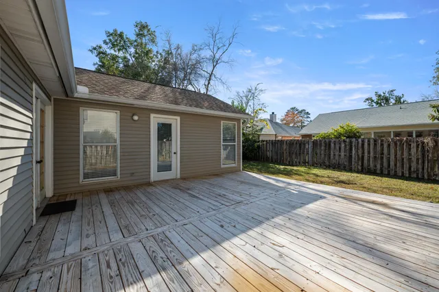 a front view of a house with a garden and yard