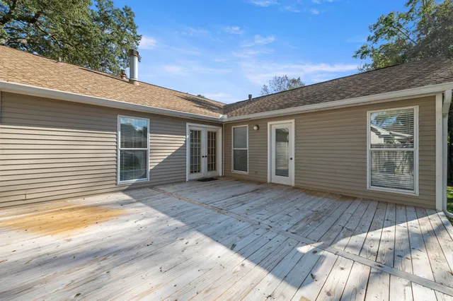 a view of a house with a yard and large tree