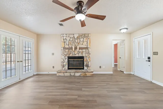 wooden floor in an empty room with a fireplace