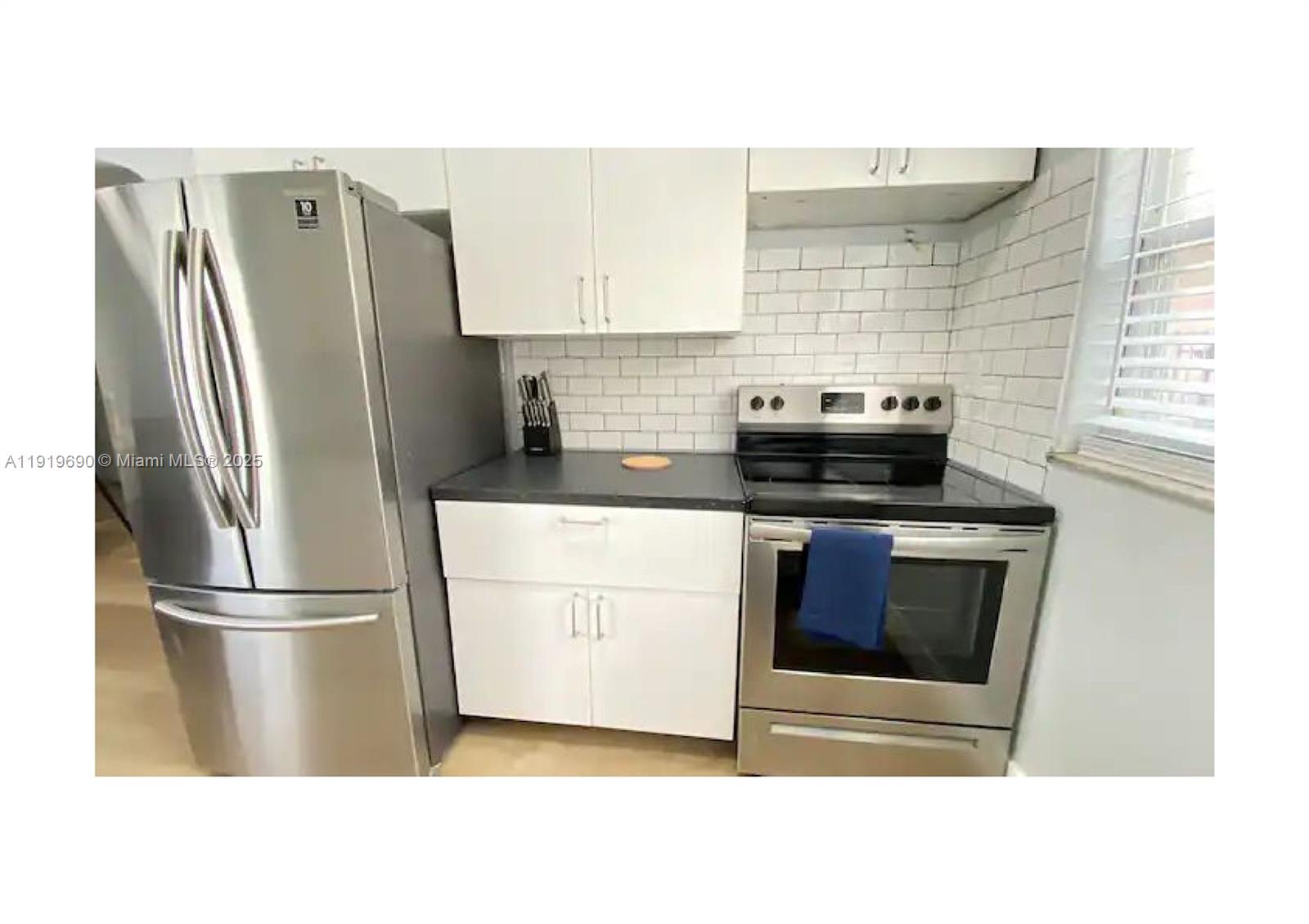 843-845 Northwest 3rd Street, Unit A Miami, FL 33128 - Photo 6 of 20 a kitchen with stainless steel appliances and refrigerator