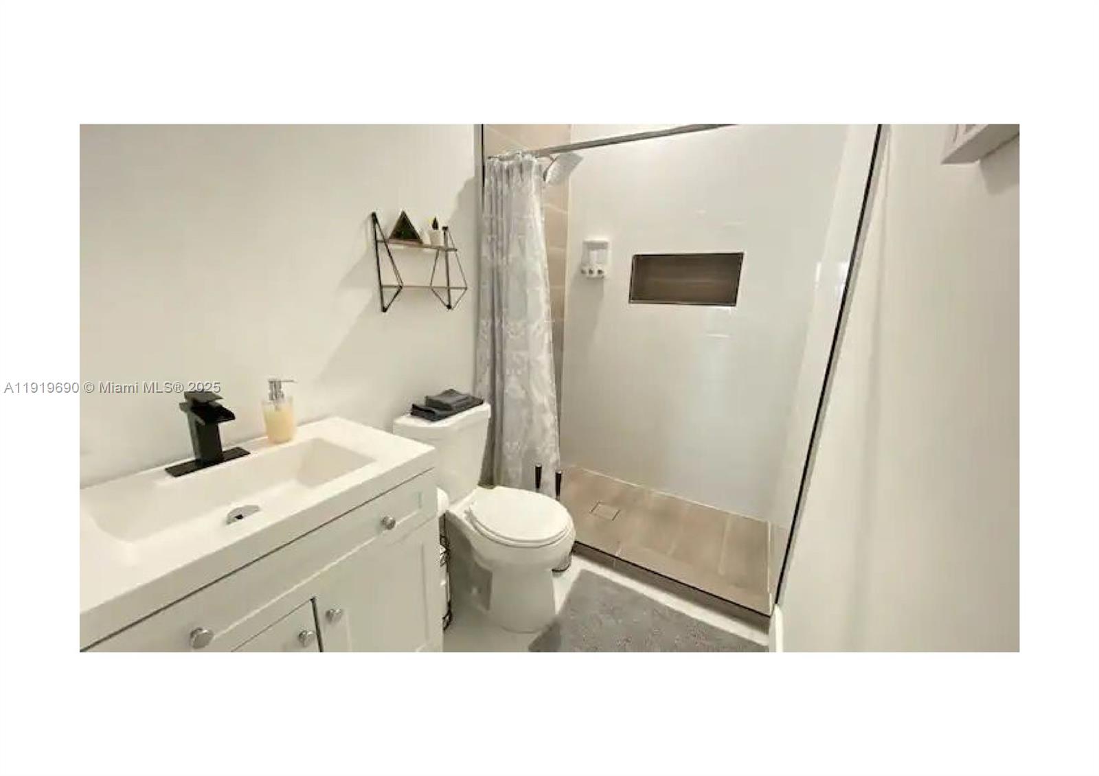 843-845 Northwest 3rd Street, Unit A Miami, FL 33128 - Photo 8 of 20 a bathroom with a sink a toilet and shower