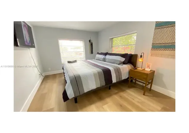 a living room with a bed furniture and a window