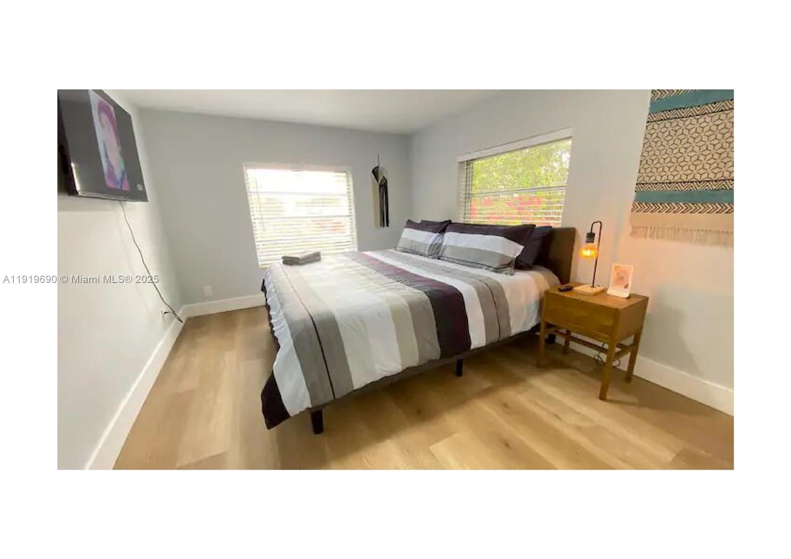 843-845 Northwest 3rd Street, Unit A Miami, FL 33128 - Photo 9 of 20 a living room with a bed furniture and a window