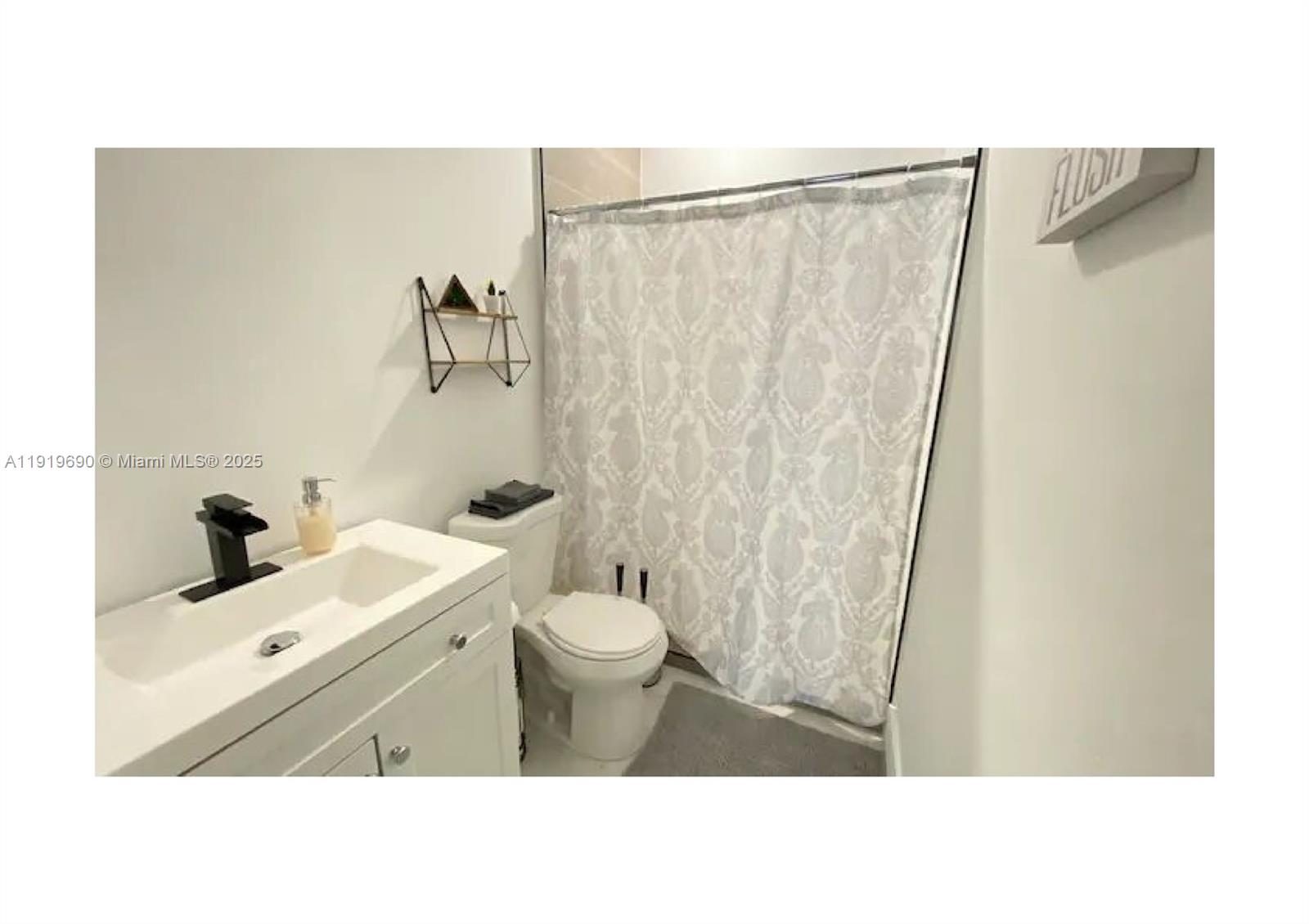 843-845 Northwest 3rd Street, Unit A Miami, FL 33128 - Photo 10 of 20 a bathroom with a sink and a mirror