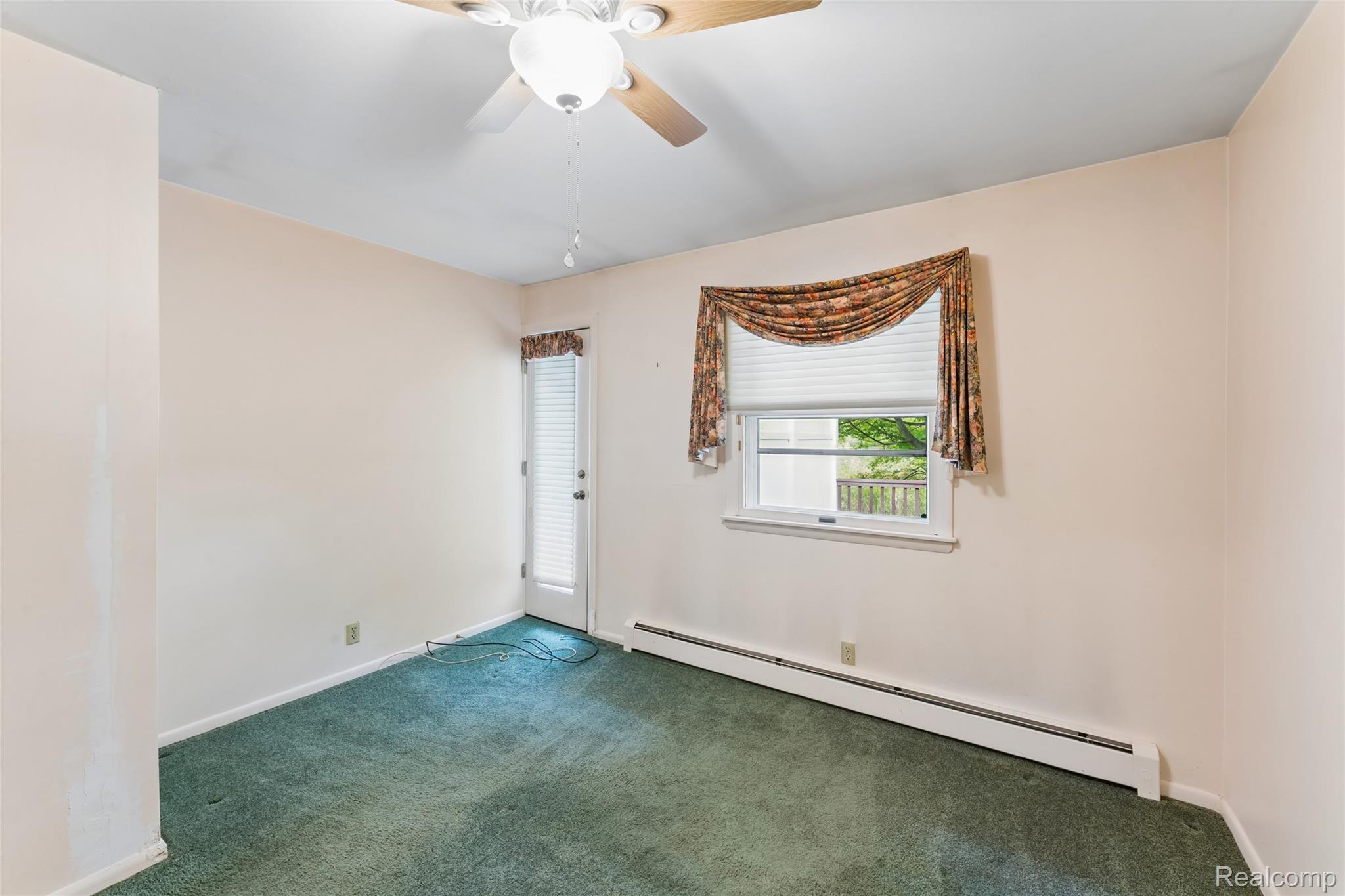 422 East Road Holly, MI 48442 - Photo 32 of 51 Room featuring wall-to-wall green carpeting, a ceiling fan, and light-toned wall finishes