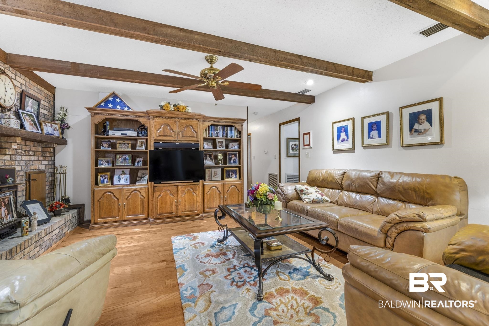 10207 Plantation Drive Daphne, AL 36526 - Photo 33 of 48 Living area featuring a ceiling fan, beam ceiling, light wood-style floors, and a fireplace