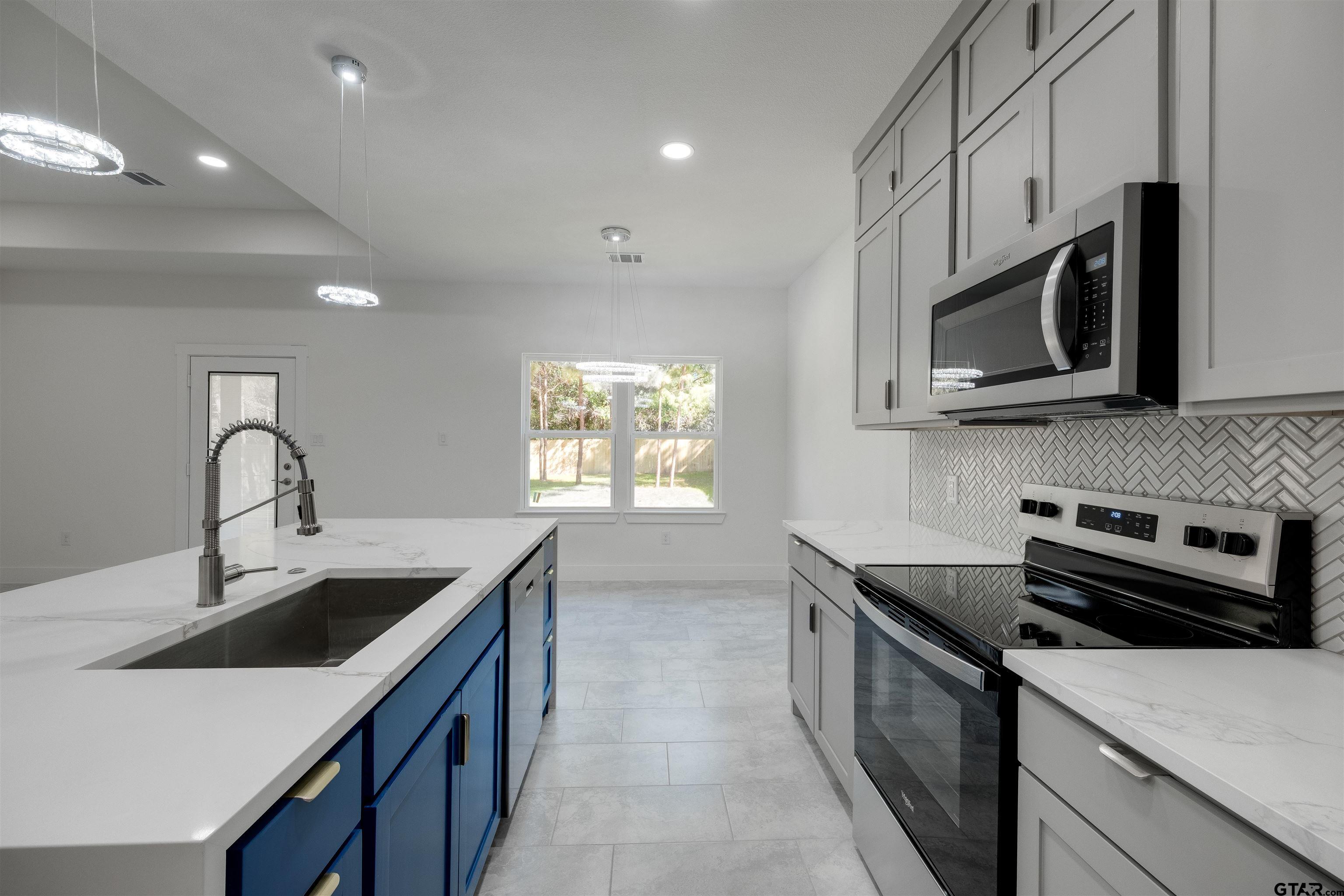 201 Victory Street Palestine, TX 75803 - Photo 11 of 37 a kitchen that has a sink and a stove