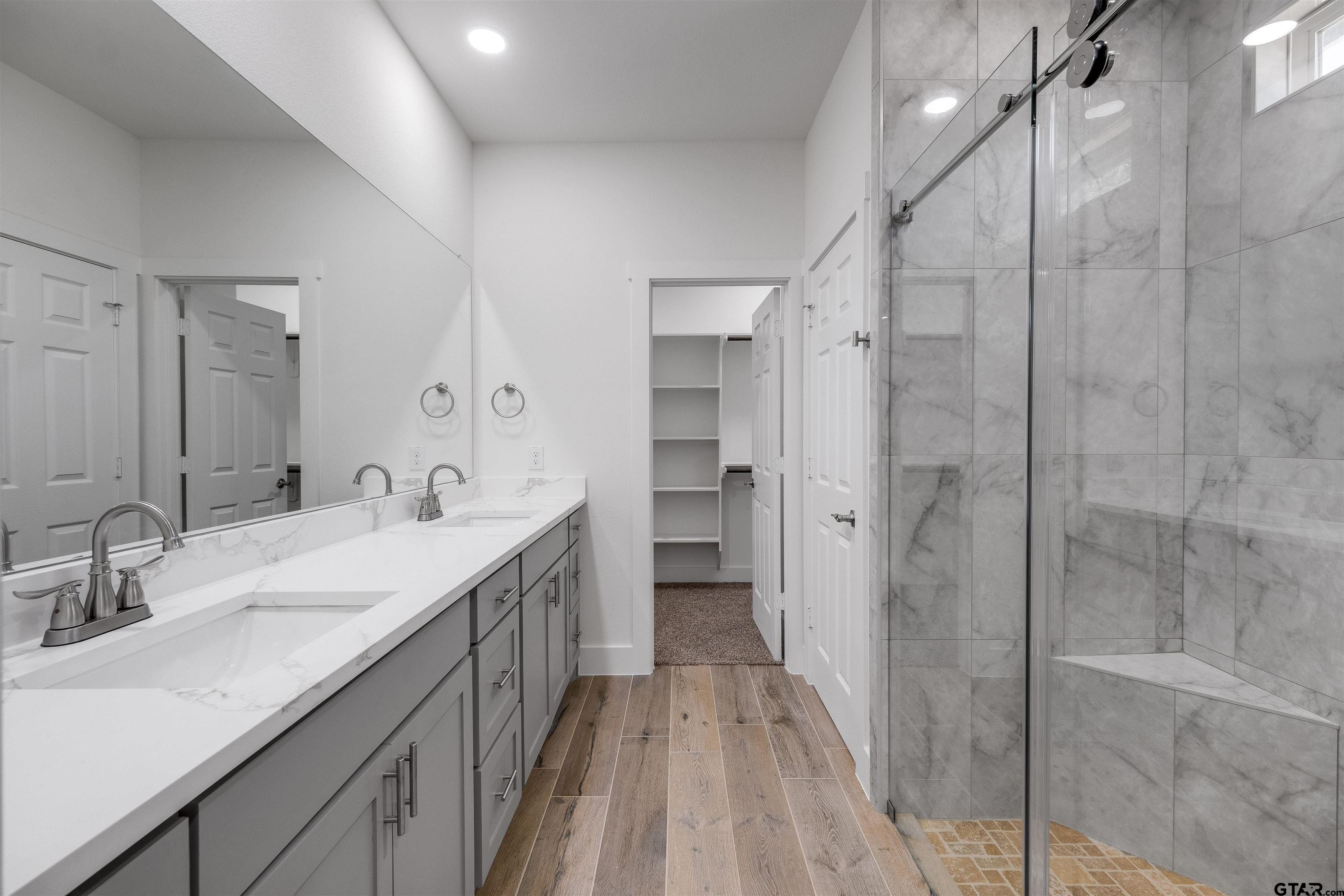 201 Victory Street Palestine, TX 75803 - Photo 20 of 37 a spacious bathroom with a double vanity sink a mirror and shower