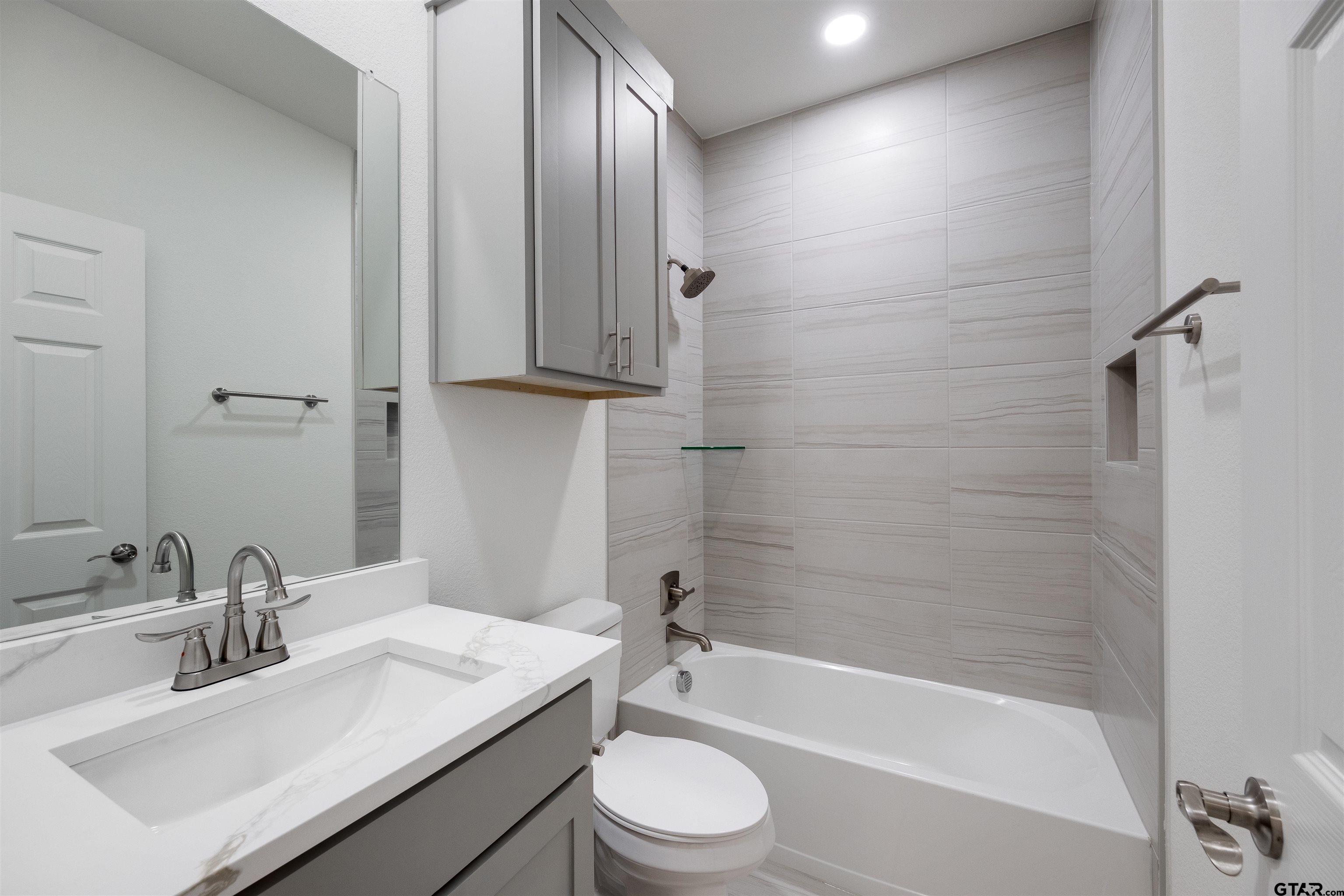 201 Victory Street Palestine, TX 75803 - Photo 23 of 37 a bathroom with a granite countertop sink toilet and shower