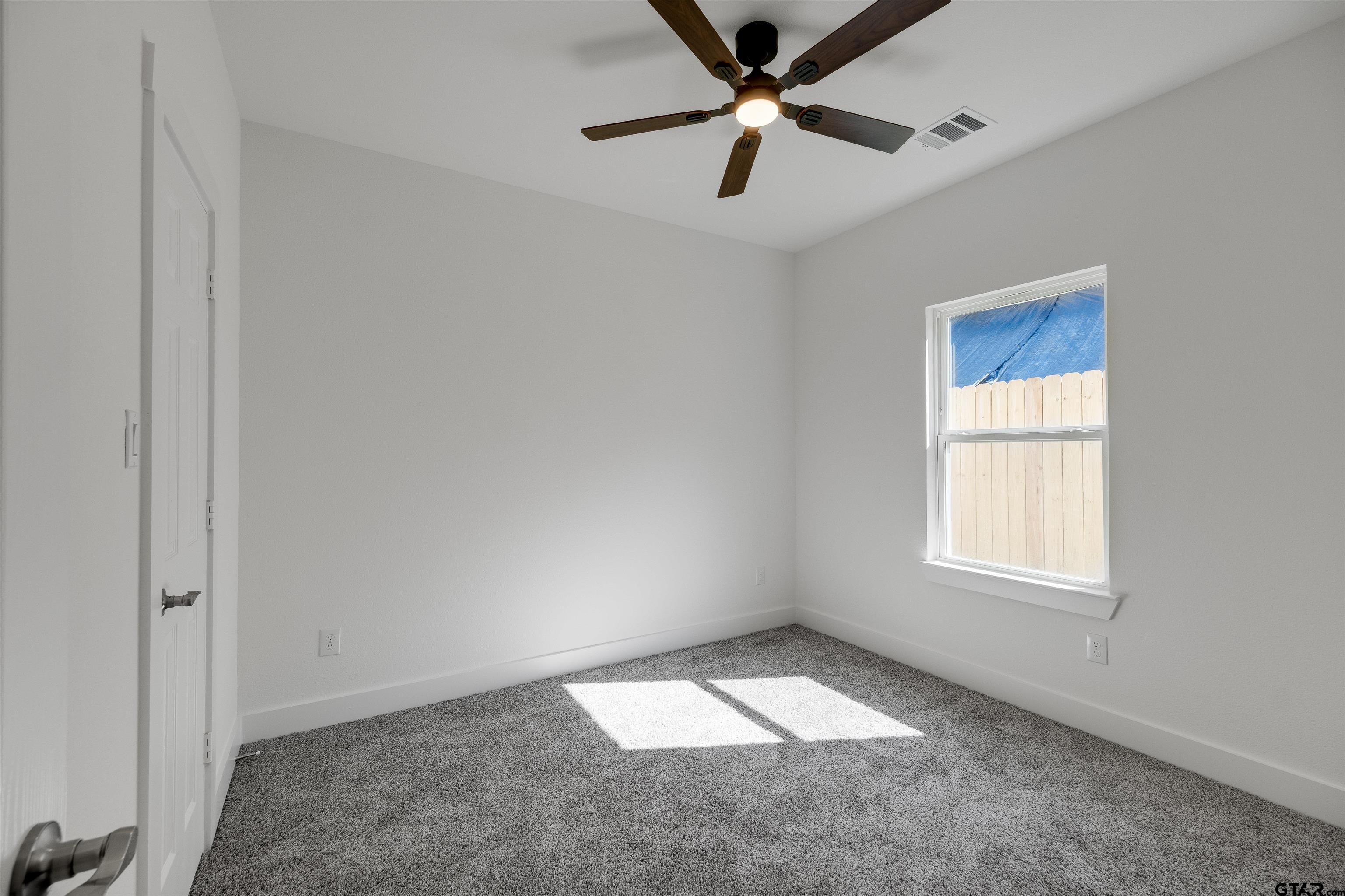 201 Victory Street Palestine, TX 75803 - Photo 25 of 37 an empty room with a window and a fan
