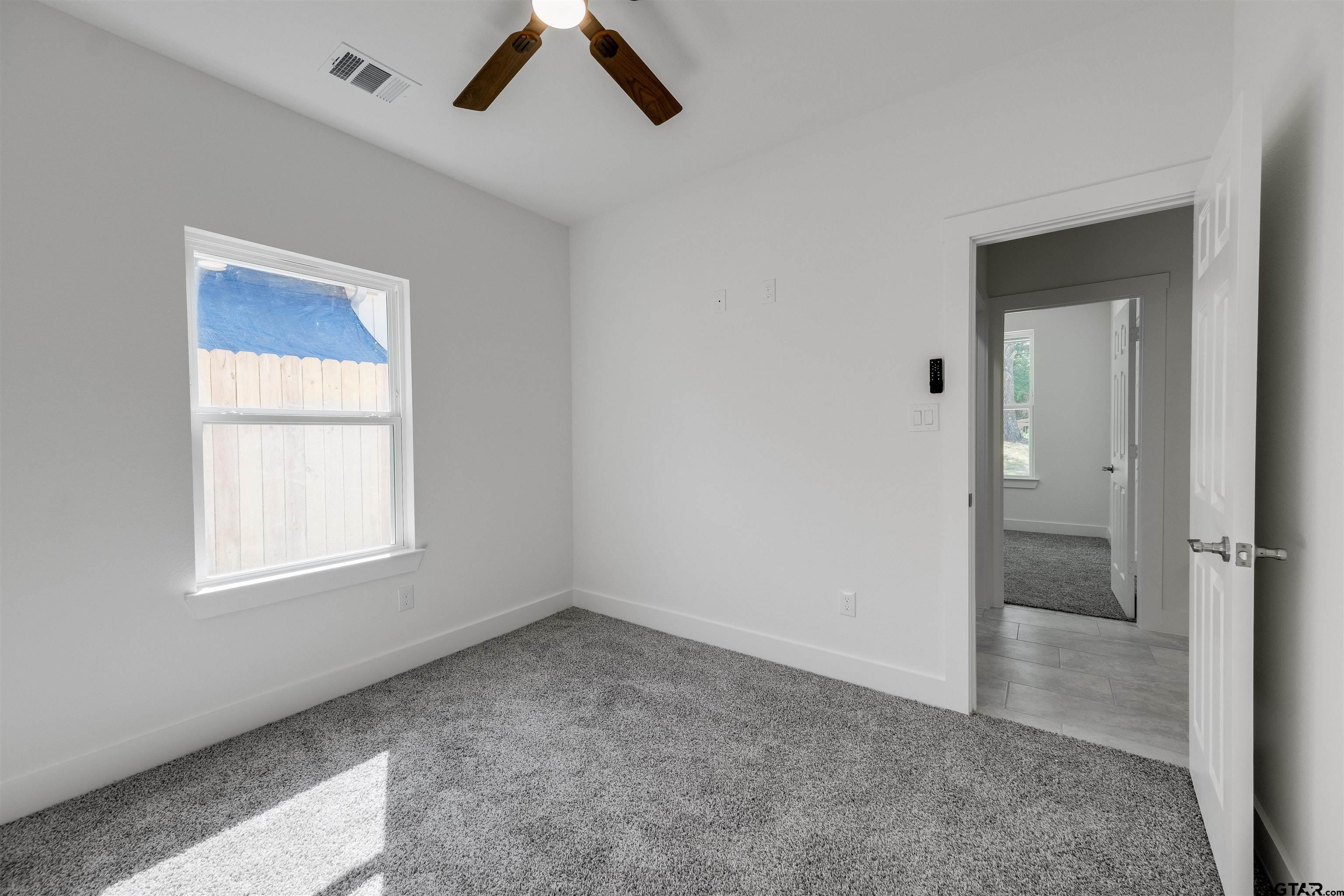 201 Victory Street Palestine, TX 75803 - Photo 27 of 37 wooden floor and window in an empty room