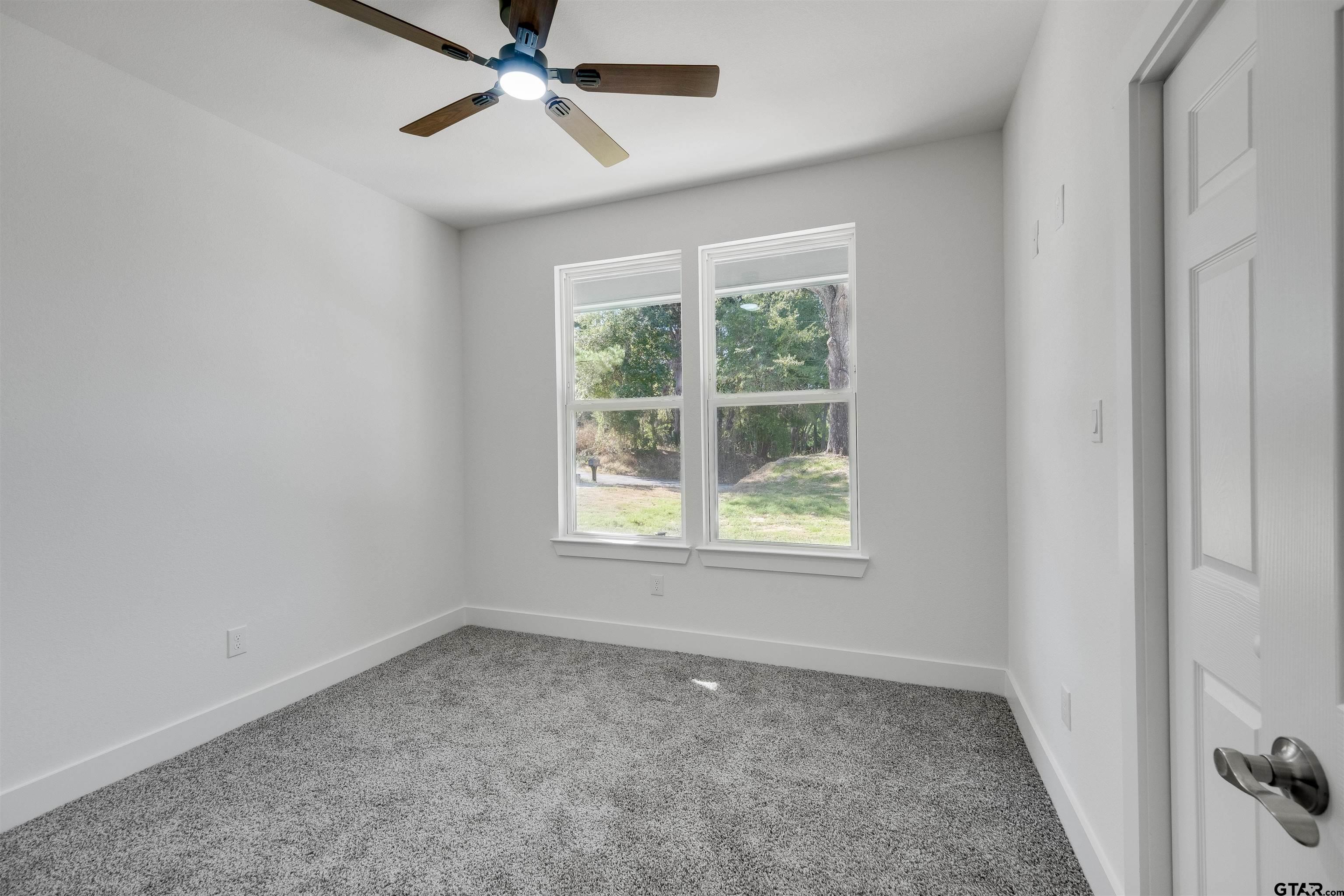 201 Victory Street Palestine, TX 75803 - Photo 29 of 37 an empty room with a window and a fan