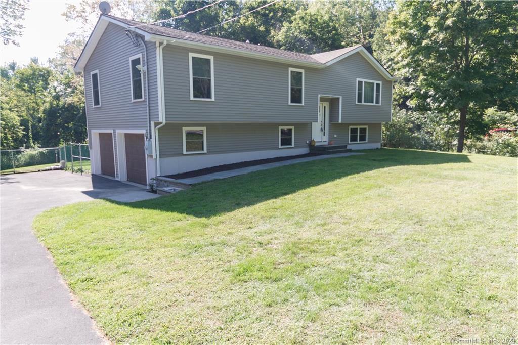a front view of a house with a yard and garage