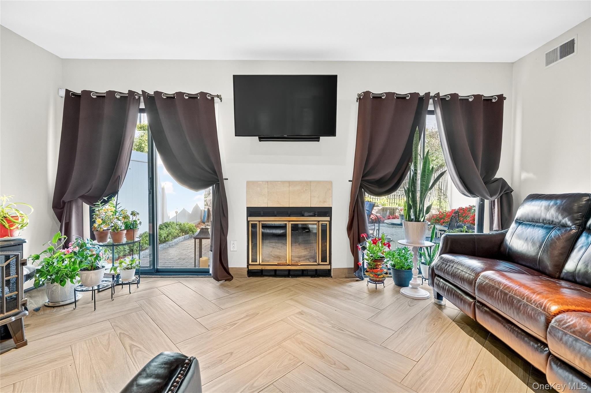 66 Leroy Avenue Valhalla, NY 10595 - Photo 13 of 31 a living room with furniture a flat screen tv and a fireplace