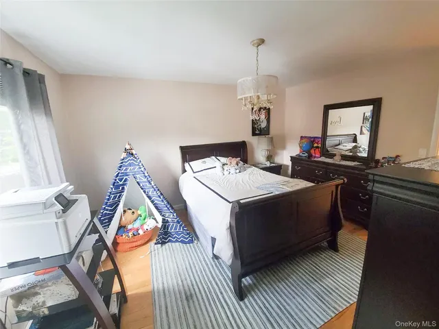 a bedroom with bed and a chandelier