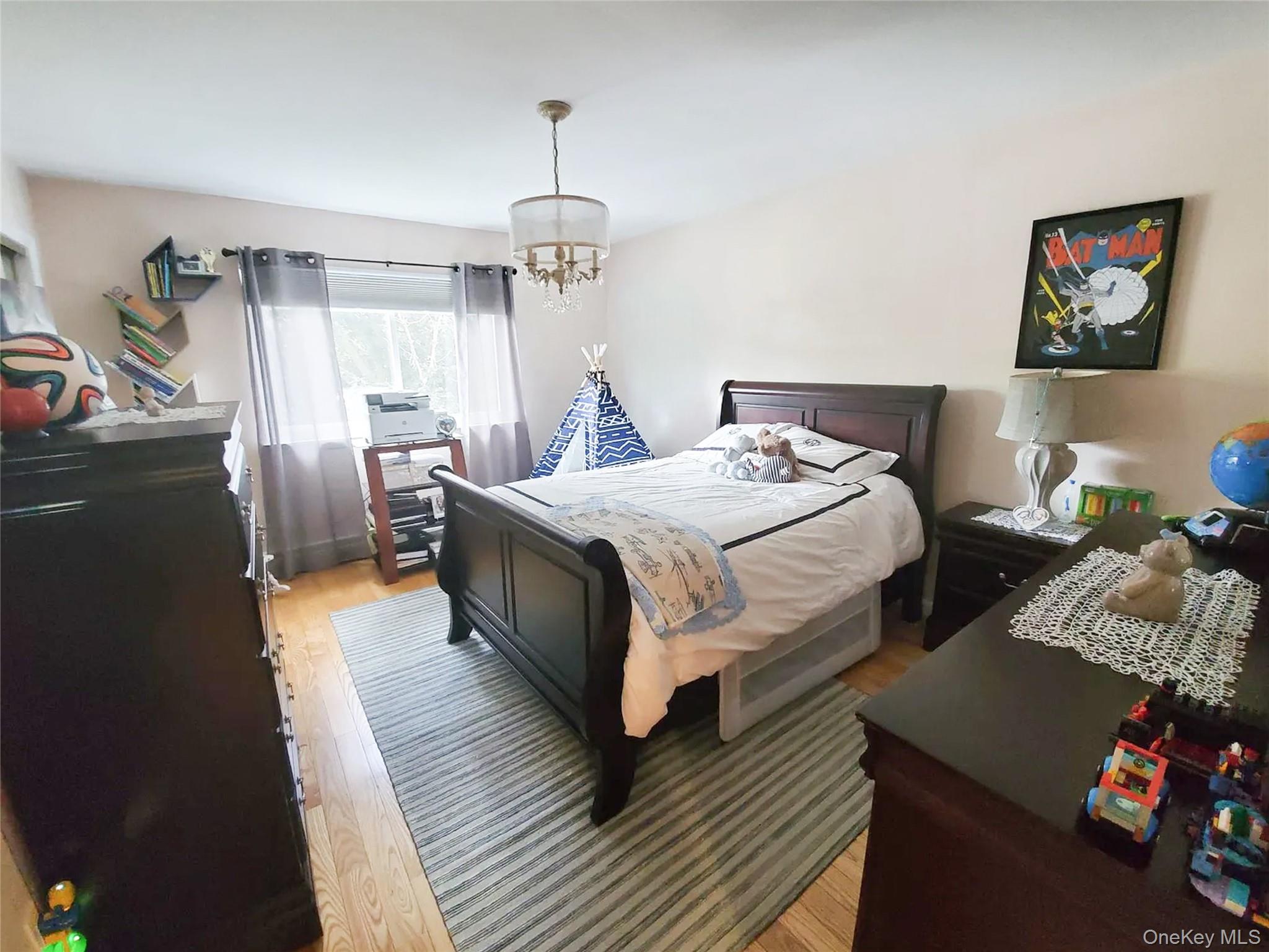 66 Leroy Avenue Valhalla, NY 10595 - Photo 19 of 31 a bedroom with bed and a chandelier