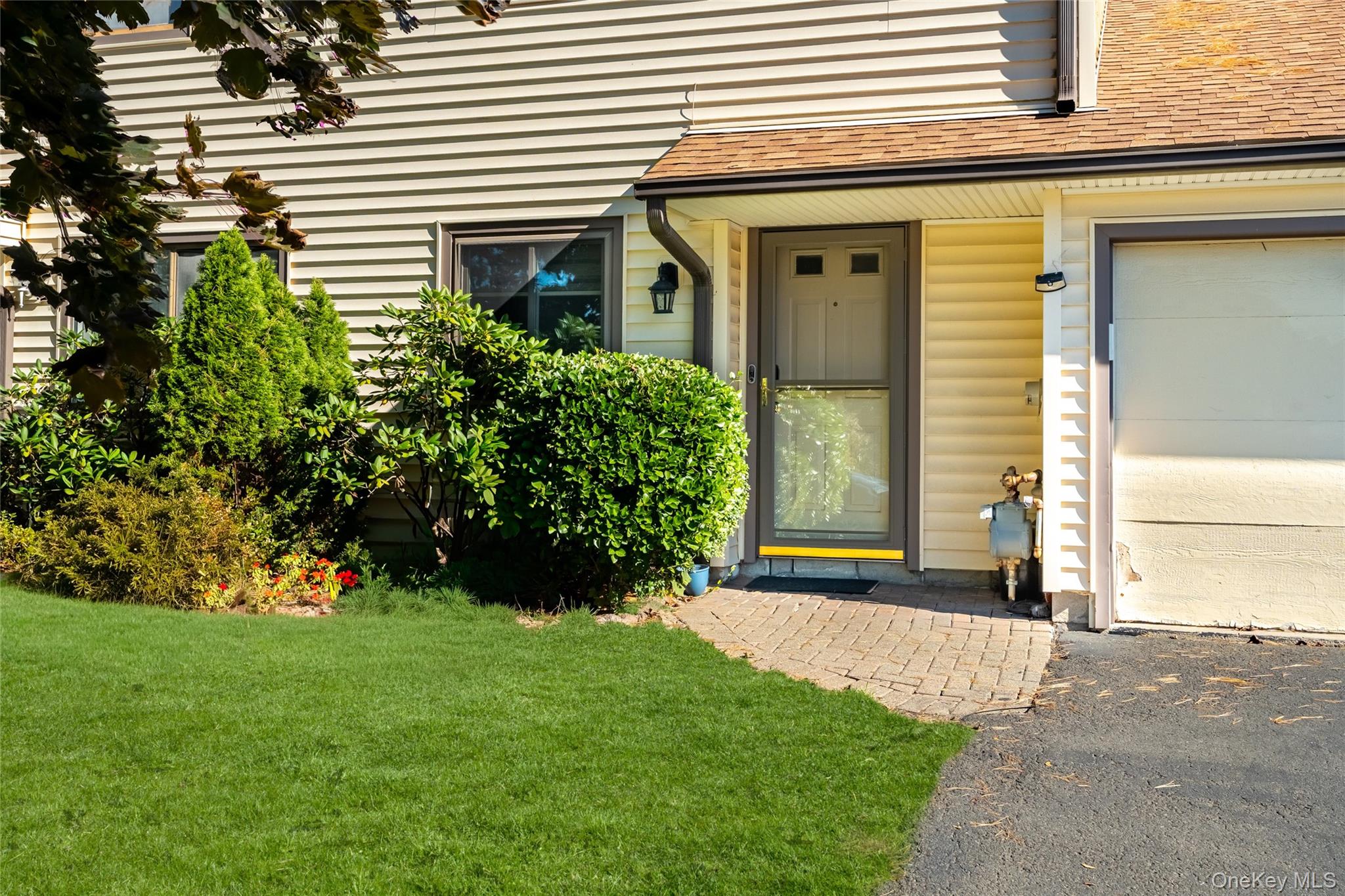 66 Leroy Avenue Valhalla, NY 10595 - Photo 2 of 31 a front view of a house with a yard and garage
