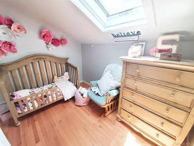 a bedroom with furniture and a wooden floor