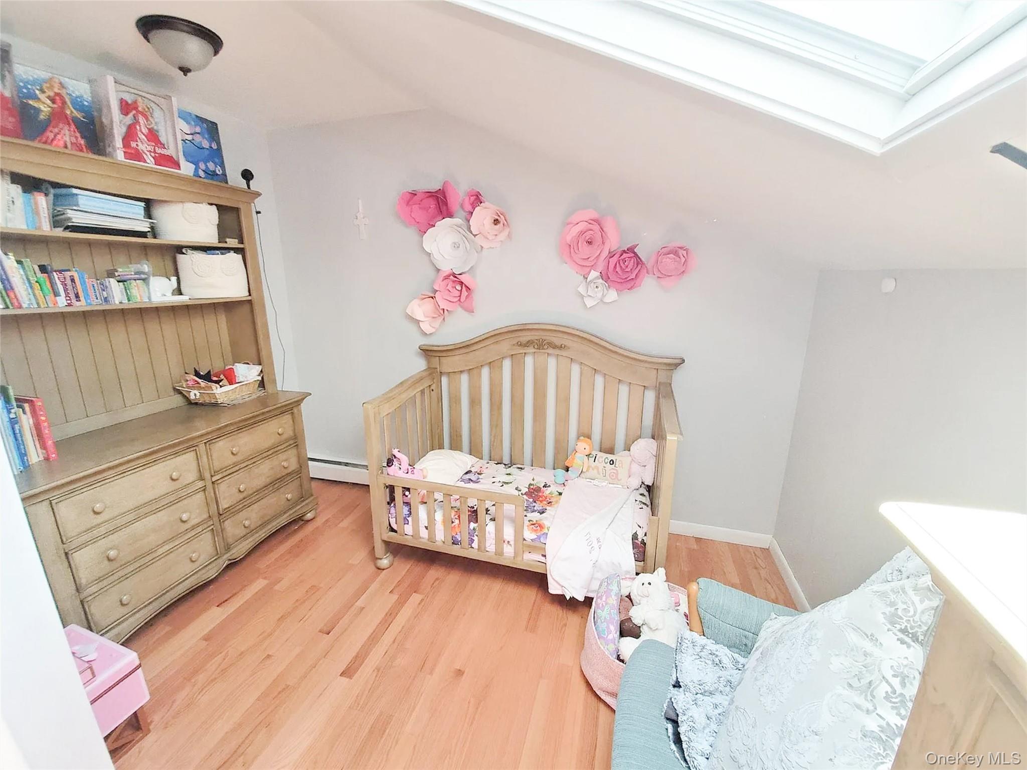 66 Leroy Avenue Valhalla, NY 10595 - Photo 22 of 31 a bedroom with furniture and a wooden floor