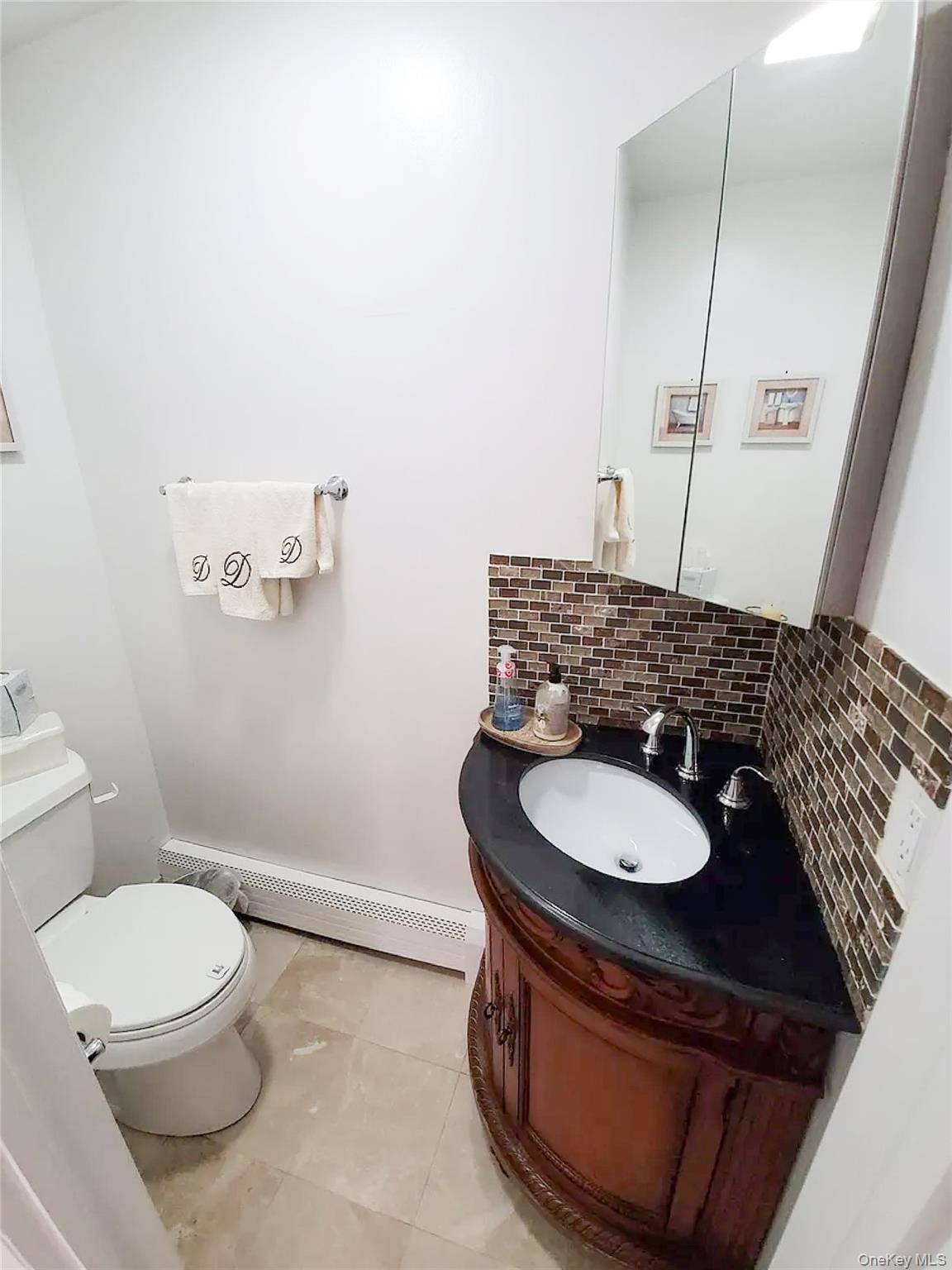 66 Leroy Avenue Valhalla, NY 10595 - Photo 25 of 31 a bathroom with a sink toilet and mirror