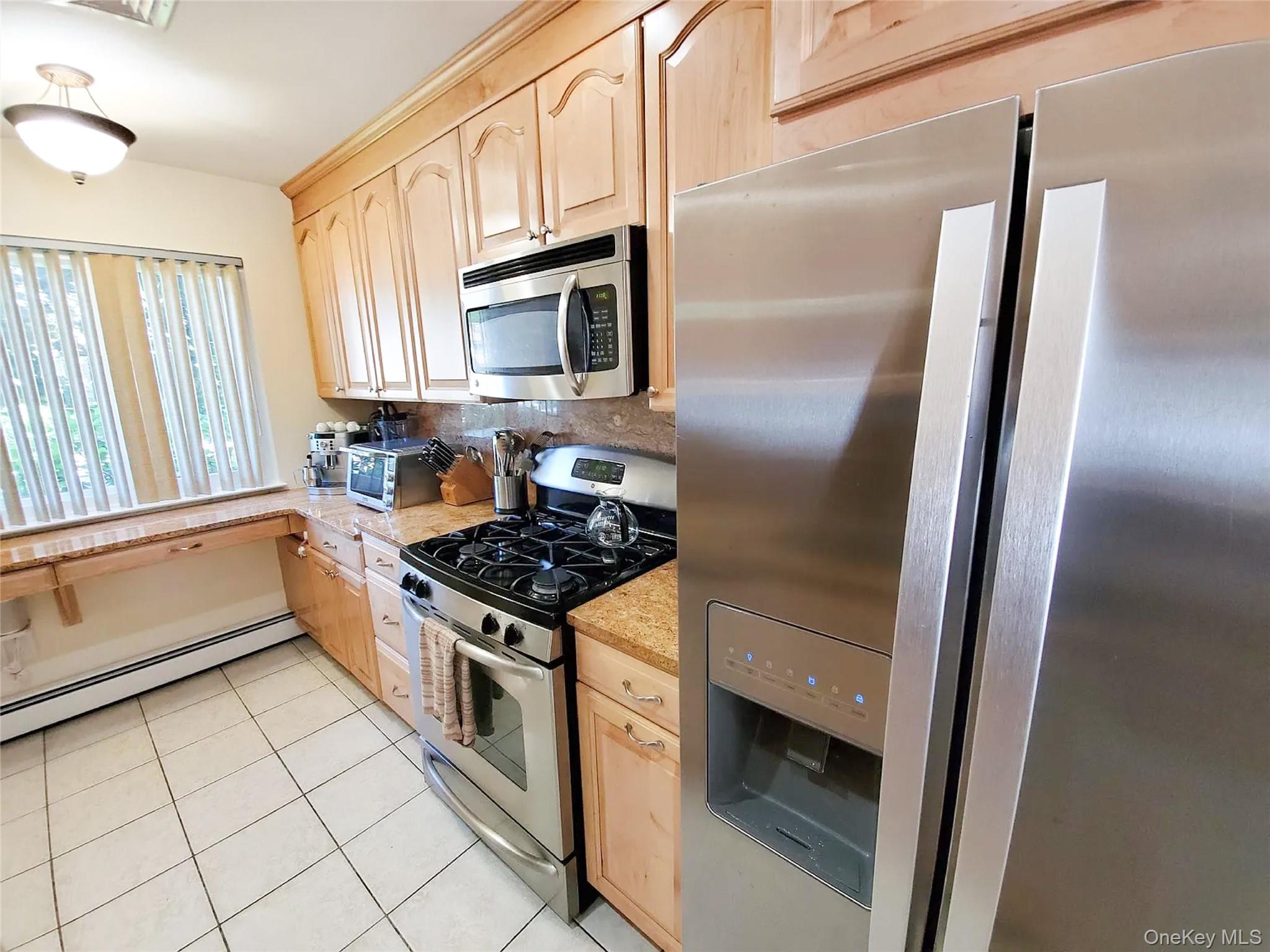 66 Leroy Avenue Valhalla, NY 10595 - Photo 6 of 31 a kitchen with white cabinets and a stove top oven