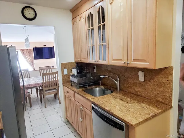 a kitchen with a sink and a stove top oven