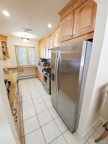 a kitchen with stainless steel appliances a refrigerator and microwave