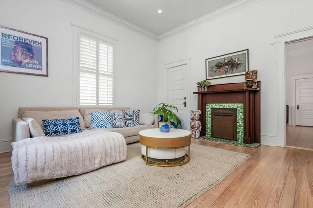 a spacious bedroom with a bed and wooden floor