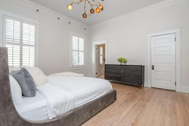 a bedroom with a bed and a chandelier