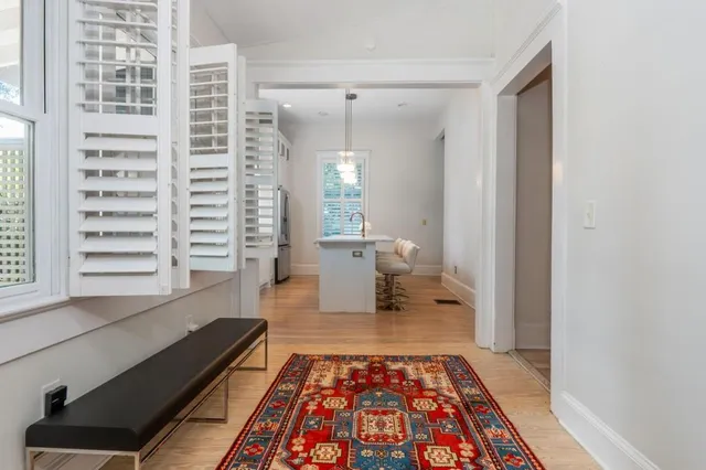 a kitchen with stainless steel appliances granite countertop a refrigerator a sink a stove and a refrigerator