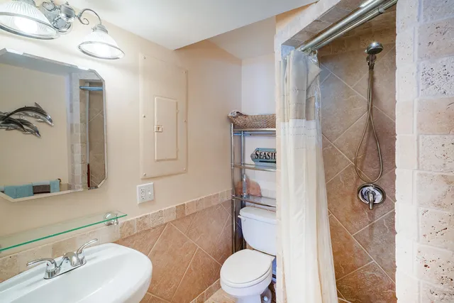 a bathroom with a sink toilet and shower