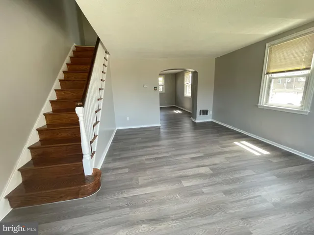a view of an entryway with wooden floor